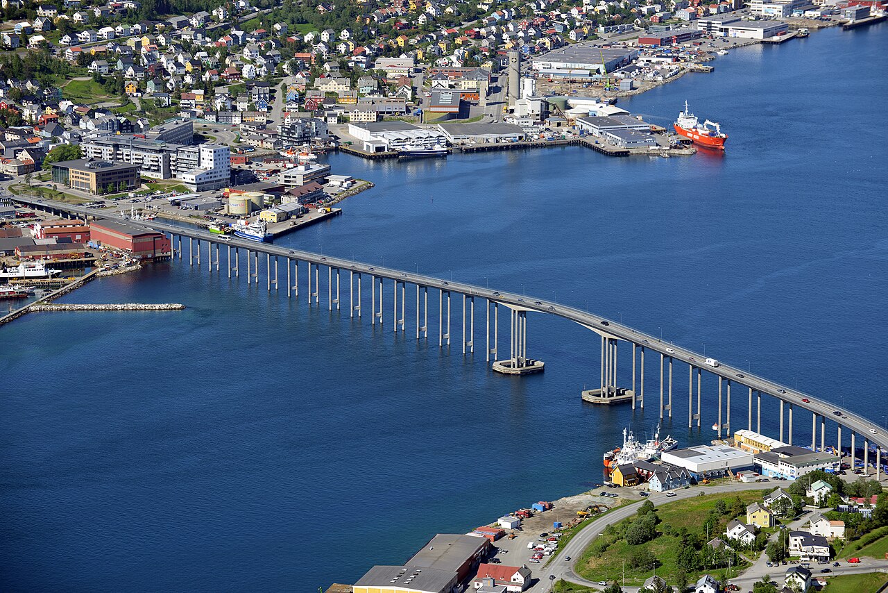Aerial view over Tromsø city centre and the Tromsø Bridge across the blue sound